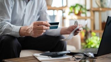 hombre mayor de cerca paga facturas con tarjeta de crédito - crédito fotografías e imágenes de stock